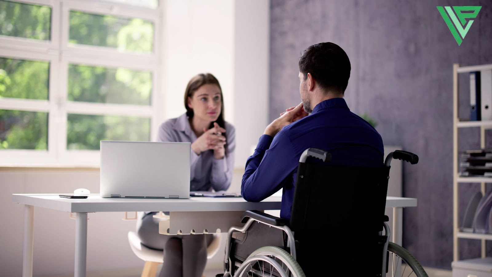 How to Determine Liability & Negligence in a Personal Injury Case - a man on a wheelchair having a conversation with a lawyer