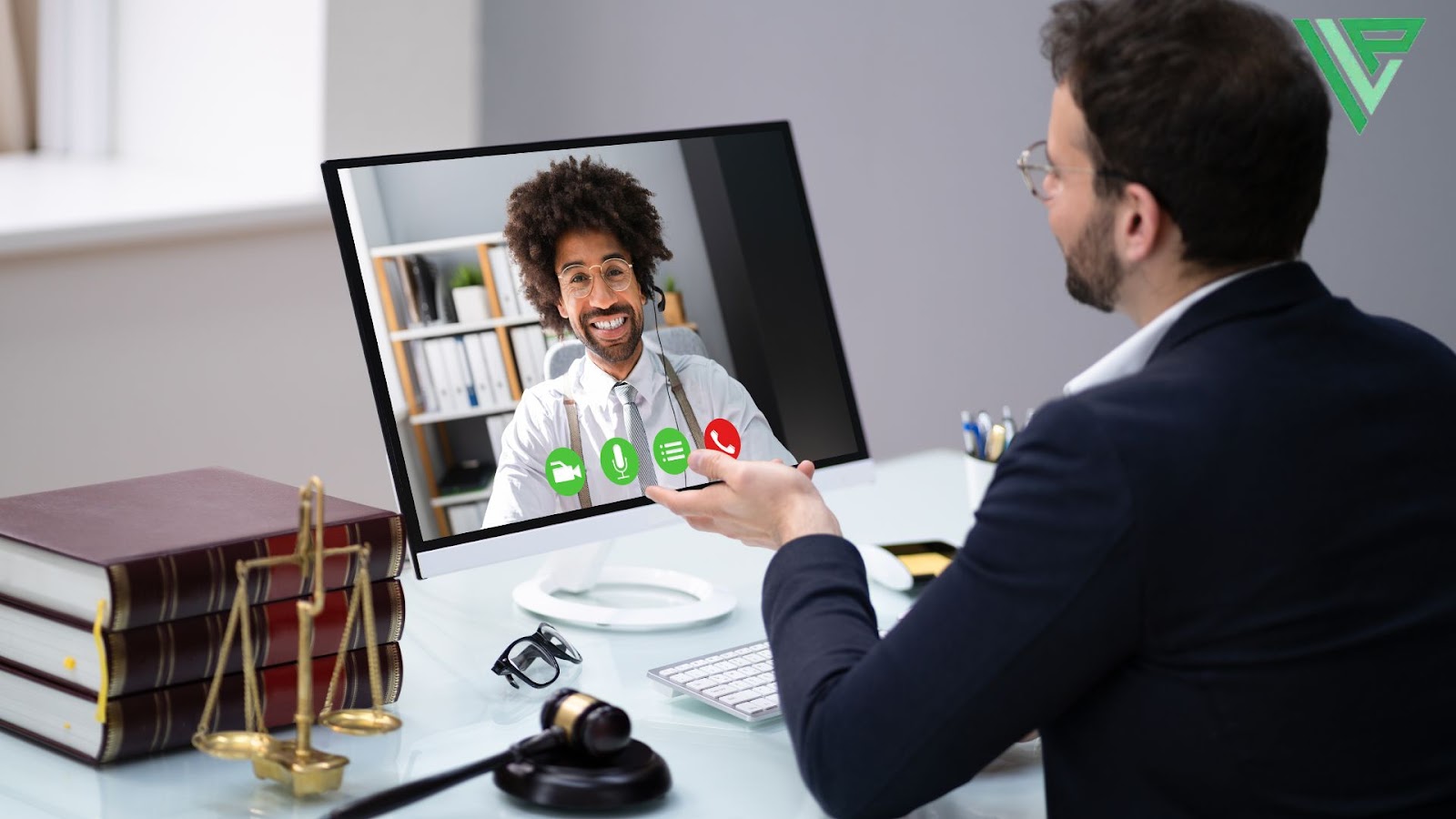 A person having a video call with a professional in an office setting about their insurance coverage, with legal books, a gavel, and office supplies visible on the desk.